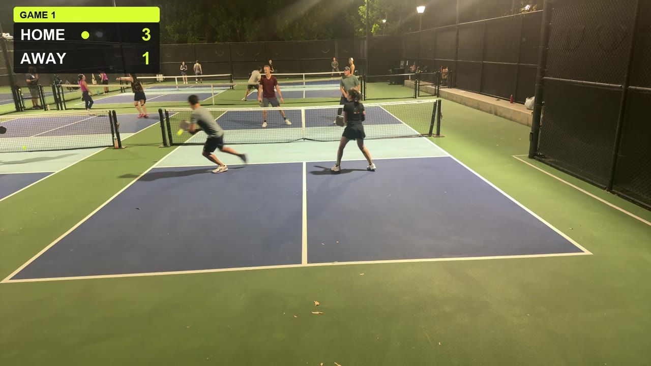 A real frame from a recorded night doubles pickleball game: four players on a lit court, with the CourtCast score bug in the top-left corner reading Home 3, Away 1.